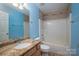 Bright blue bathroom with granite counters, tile flooring and shower over tub at 122 Ardmore Pl, Mooresville, NC 28117