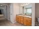 Bright bathroom featuring double vanity, granite counters, tile flooring and tub under window at 122 Ardmore Pl, Mooresville, NC 28117