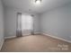 Neutral bedroom with carpet, large window with curtains, and neutral walls at 122 Ardmore Pl, Mooresville, NC 28117