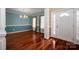 Formal dining room with hardwood floors, classic chandelier, and elegant wainscoting near the front entry at 122 Ardmore Pl, Mooresville, NC 28117