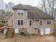 The home features a back exterior with a deck, lush lawn and mature trees in a peaceful setting at 122 Ardmore Pl, Mooresville, NC 28117