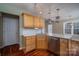 Kitchen with stainless steel appliances, a bar, and hardwood floors at 122 Ardmore Pl, Mooresville, NC 28117