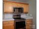 Well-appointed kitchen featuring stainless steel microwave, range, and white countertops at 122 Ardmore Pl, Mooresville, NC 28117