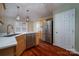 Bright kitchen featuring stainless steel appliances, an island, and hardwood floors at 122 Ardmore Pl, Mooresville, NC 28117