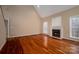 Inviting living room features hardwood floors, a cozy fireplace, high ceilings, and natural light at 122 Ardmore Pl, Mooresville, NC 28117