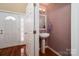 Foyer powder room with pedestal sink, decorative lighting, and hardwood flooring near the main entrance at 122 Ardmore Pl, Mooresville, NC 28117