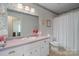 Bathroom with pink vanity and floral wallpaper at 125 1St N Ave, Conover, NC 28613