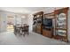 Dining room with a wooden table, chairs, hutch, and access to the backyard at 125 1St N Ave, Conover, NC 28613