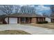 Brick ranch house with a white garage door and a long driveway at 125 1St N Ave, Conover, NC 28613