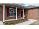 Front entrance with red door, white columns, and landscaping at 125 1St N Ave, Conover, NC 28613