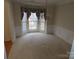 Formal dining room with bay window and carpeting at 130 Swift Creek Ln, Mooresville, NC 28115