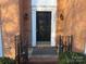 Black front door entryway with brick and wrought iron accents at 130 Swift Creek Ln, Mooresville, NC 28115