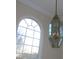 Elegant arched window with a brass chandelier at 130 Swift Creek Ln, Mooresville, NC 28115