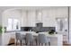 Modern kitchen with white cabinets, herringbone backsplash, and an island with seating at 1312A Reflection Pointe Blvd # 331, Belmont, NC 28012