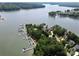 Stunning aerial view of the lakefront property with private boat docks surrounded by lush greenery and sparkling water at 1312A Reflection Pointe Blvd # 331, Belmont, NC 28012