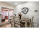 Bright dining area with a wood table and access to a screened porch at 1360 Hopewell Church Rd, Catawba, NC 28609