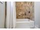 Bathroom featuring a shower/tub with updated tile at 1715 Dunkirk Dr, Charlotte, NC 28203