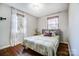 Cozy bedroom with hardwood floors, a double bed, and neutral decor at 1715 Dunkirk Dr, Charlotte, NC 28203