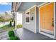 Inviting orange front door with gray siding at 1715 Dunkirk Dr, Charlotte, NC 28203