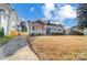 Gray house with orange door and stone accents at 1715 Dunkirk Dr, Charlotte, NC 28203