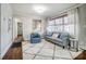 Living room with hardwood floors, gray couch, and blue accent chair at 1715 Dunkirk Dr, Charlotte, NC 28203