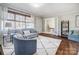 Living room with hardwood floors, gray couch, and blue accent chair at 1715 Dunkirk Dr, Charlotte, NC 28203