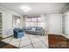 Living room with hardwood floors, a gray couch, and blue accent chair at 1715 Dunkirk Dr, Charlotte, NC 28203