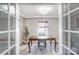 Home office features a wood desk and French doors at 1715 Dunkirk Dr, Charlotte, NC 28203