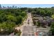 Aerial view of neighborhood streetscape and mature trees in front of the Charlotte skyline at 1912 St John St, Charlotte, NC 28216