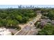 Aerial view showcases Charlotte skyline amidst lush greenery, streetscape, and urban living at 1912 St John St, Charlotte, NC 28216