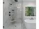 Luxurious bathroom boasts a glass shower, soaking tub, and natural light through the window at 1912 St John St, Charlotte, NC 28216