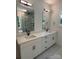 Stylish bathroom boasting double sinks, quartz countertops, modern lighting, and a glass-enclosed shower at 1912 St John St, Charlotte, NC 28216