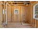 A bathroom framed in a new construction with a shower, water lines, and a window at 1912 St John St, Charlotte, NC 28216