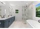 Modern bathroom with double vanity, soaking tub, and walk-in shower at 1912 St John St, Charlotte, NC 28216