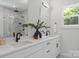 Modern bathroom featuring double sinks, quartz countertop, sleek black hardware, and stylish mirrors at 1912 St John St, Charlotte, NC 28216