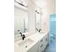 This bathroom features a double vanity with black fixtures and a view into the water closet at 1912 St John St, Charlotte, NC 28216