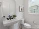 Well-lit bathroom featuring a modern vanity, toilet, and a picture adding to the clean design at 1912 St John St, Charlotte, NC 28216