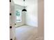 Sunny bedroom showcasing light wood floors, white walls, ample natural light, and black door hardware at 1912 St John St, Charlotte, NC 28216