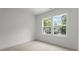 Inviting bedroom filled with natural light featuring a view of the home's landscaped exterior at 1912 St John St, Charlotte, NC 28216