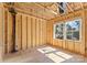 A bright new construction bedroom displaying wood framing, and a window with natural light at 1912 St John St, Charlotte, NC 28216