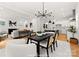 Dining area with black table, pendant lights, and kitchen access at 1912 St John St, Charlotte, NC 28216