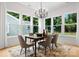 Dining room filled with natural light boasts modern chandelier and views of the outdoors at 1912 St John St, Charlotte, NC 28216