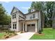 Charming two-story home with light-colored siding, a dormer, a covered front porch, and an attached one-car garage at 1912 St John St, Charlotte, NC 28216