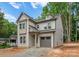 Stylish two-story home with gray siding, a modern roofline, and an attached gray garage at 1912 St John St, Charlotte, NC 28216