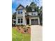 Charming two-story home with a manicured lawn, inviting curb appeal, and attached one car garage at 1912 St John St, Charlotte, NC 28216