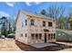 Exterior of a two story new construction home with visible window frames and a concrete patio in progress at 1912 St John St, Charlotte, NC 28216