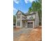 Attractive gray two-story home with an attached garage and modern design elements in a lush setting at 1912 St John St, Charlotte, NC 28216