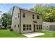 Rear view of the two-story home showcasing siding, multiple windows, and a well-maintained lawn at 1912 St John St, Charlotte, NC 28216