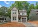 Charming two-story home featuring a gray exterior, attached garage, and manicured front yard at 1912 St John St, Charlotte, NC 28216