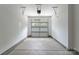 A spacious garage features concrete flooring, bright lighting, and plenty of room for vehicles at 1912 St John St, Charlotte, NC 28216
